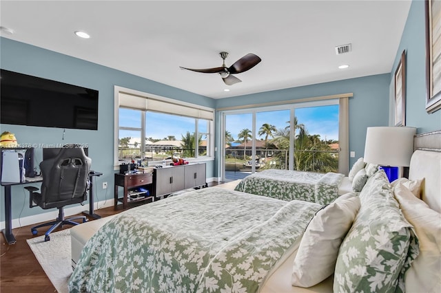 bedroom with multiple windows, access to outside, dark hardwood / wood-style floors, and ceiling fan