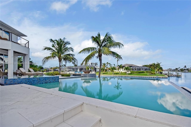 view of swimming pool featuring a water view