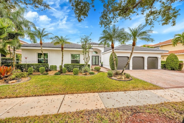 view of front of home featuring a garage and a front lawn