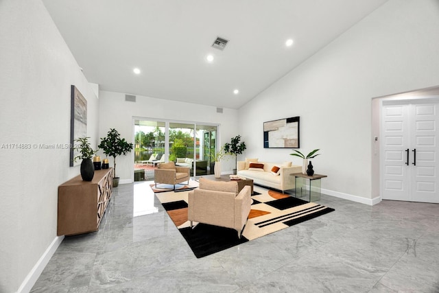 living room with high vaulted ceiling