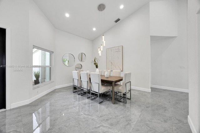 dining room with a high ceiling