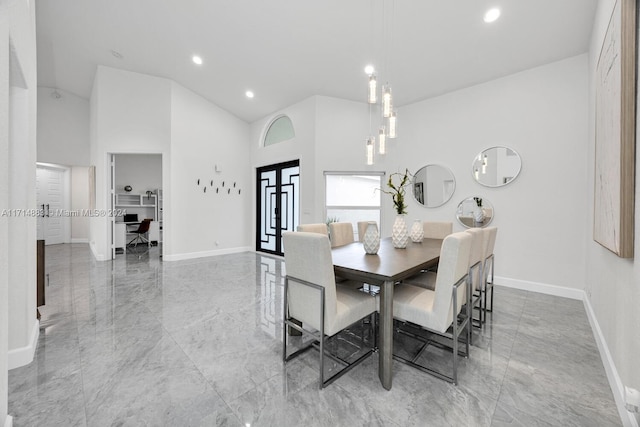 dining area with a towering ceiling