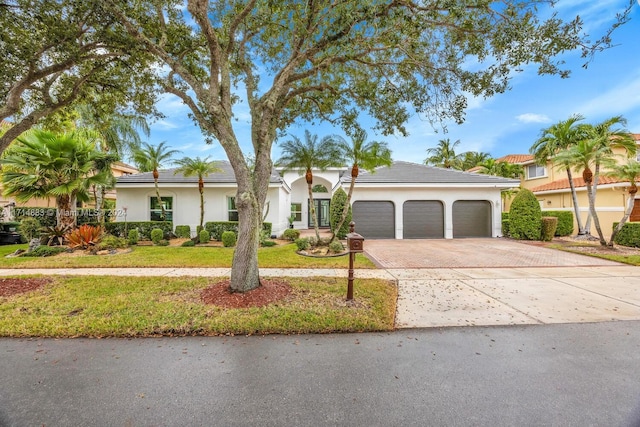 ranch-style house with a front yard and a garage