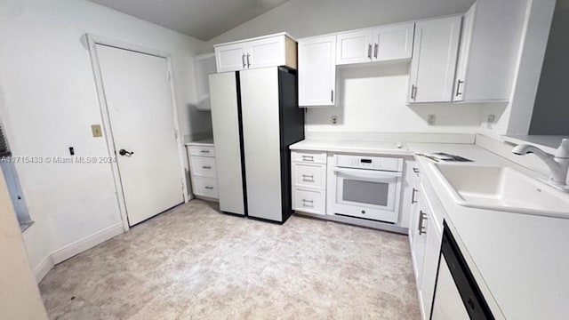 kitchen with vaulted ceiling, white cabinetry, sink, and white appliances