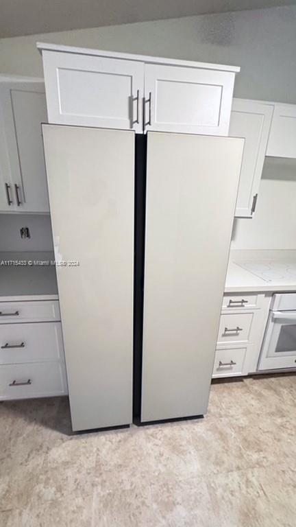 kitchen with oven and white cabinetry