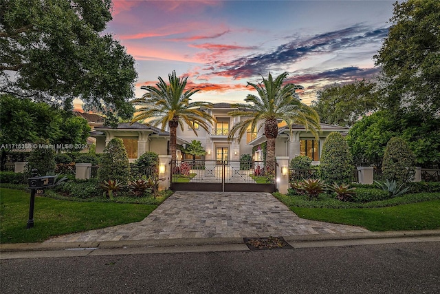 mediterranean / spanish house with a lawn