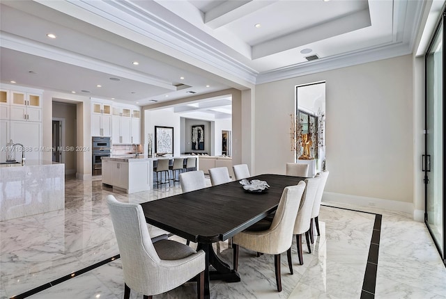 dining area featuring crown molding, sink, and a tray ceiling