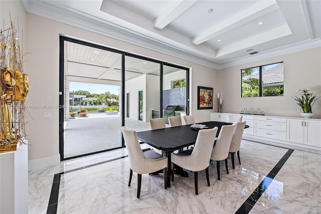 dining space with ornamental molding and a tray ceiling