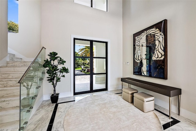 entryway featuring french doors and a high ceiling