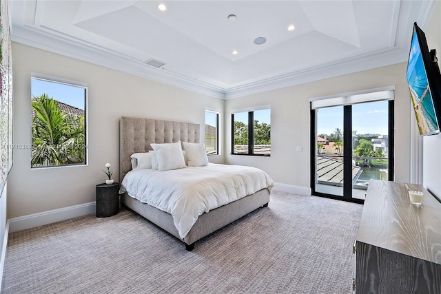 bedroom with a tray ceiling, crown molding, light colored carpet, and access to outside