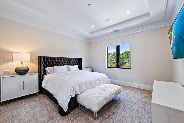 bedroom featuring a tray ceiling and crown molding