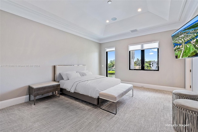 bedroom with a raised ceiling, light colored carpet, and ornamental molding