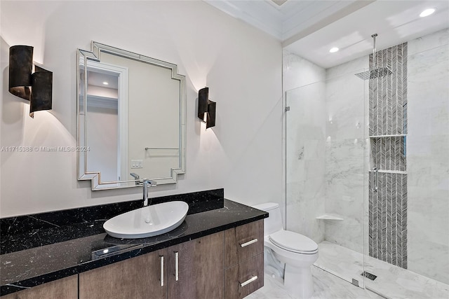 bathroom with a shower with door, vanity, ornamental molding, and toilet