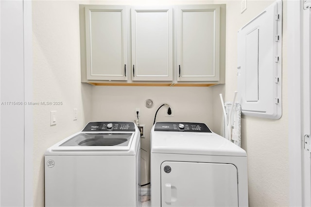 laundry room with cabinets, electric panel, and independent washer and dryer