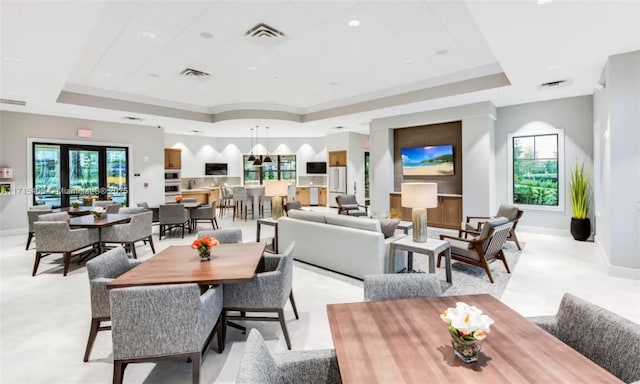 dining area with ornamental molding and a raised ceiling