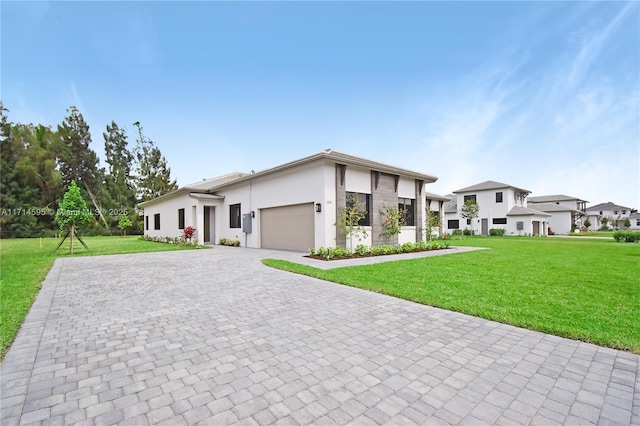 view of front of house featuring a garage and a front lawn