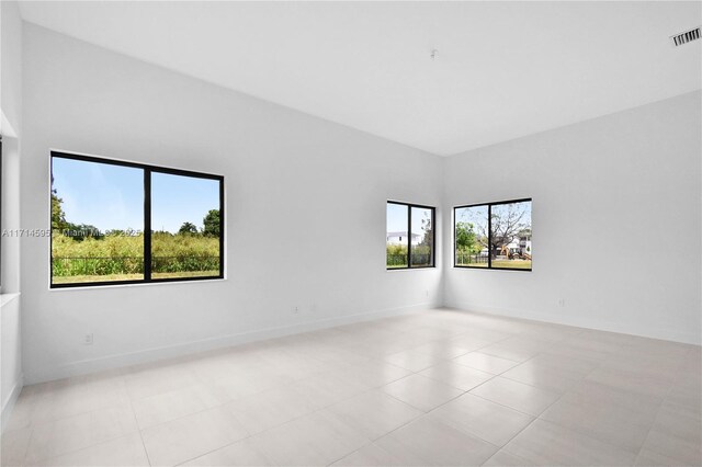 unfurnished living room with light tile patterned flooring