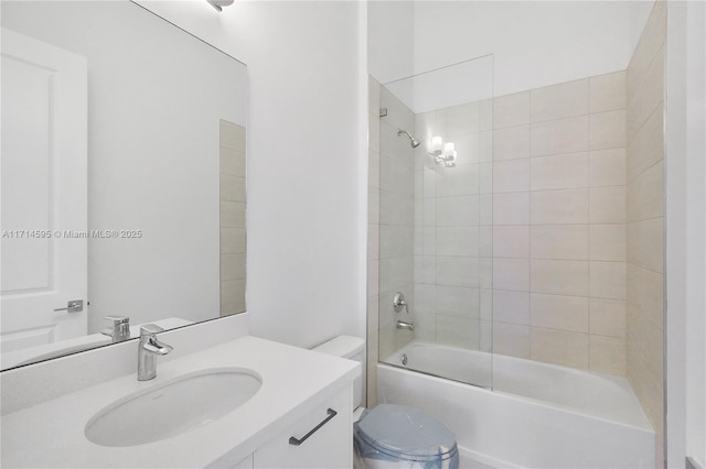 full bathroom with tiled shower / bath combo, toilet, and vanity