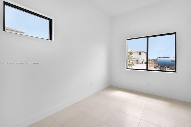 unfurnished room featuring light tile patterned flooring