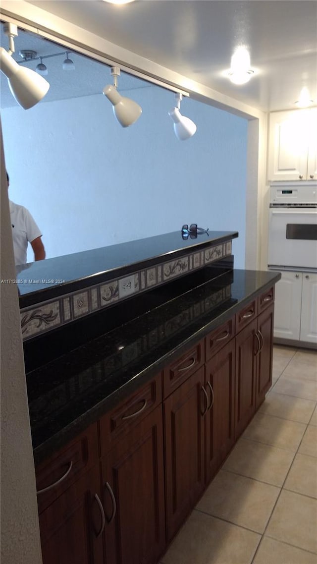 kitchen featuring white oven and light tile patterned flooring