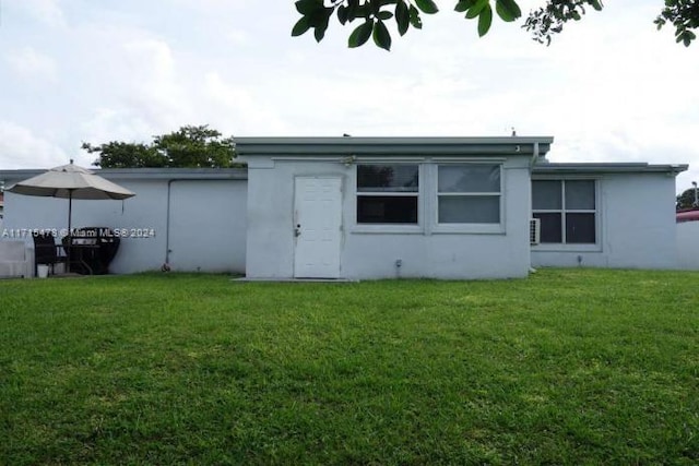 rear view of property with a yard