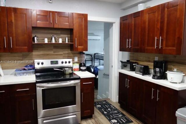 kitchen with electric range and decorative backsplash