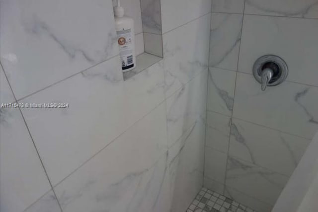 bathroom with tiled shower