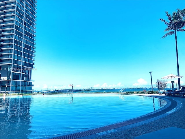 view of pool with a water view