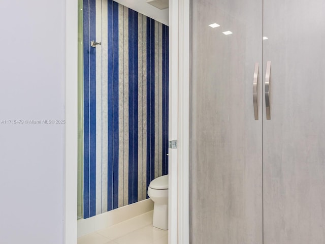 bathroom featuring tile patterned flooring and toilet