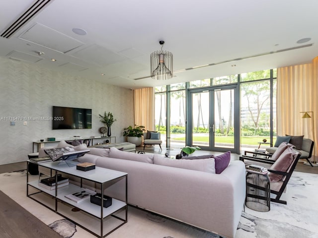 living room with french doors, expansive windows, and a notable chandelier