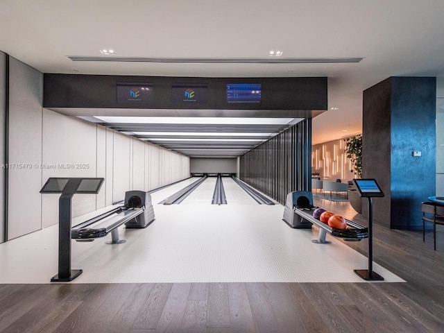 rec room with wood-type flooring and a bowling alley