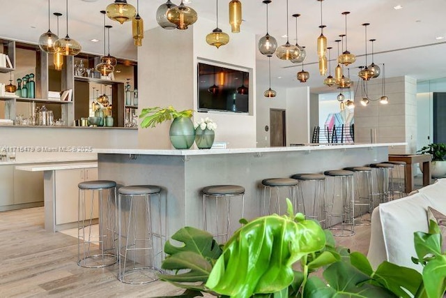 kitchen with hanging light fixtures and a breakfast bar area