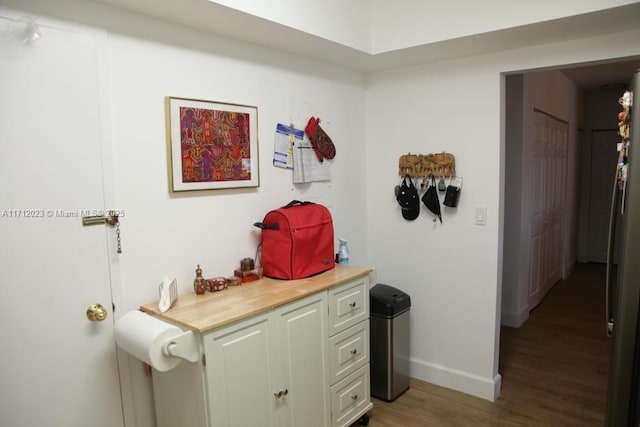 interior space with baseboards and wood finished floors