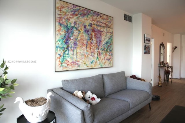 living room with visible vents and wood finished floors