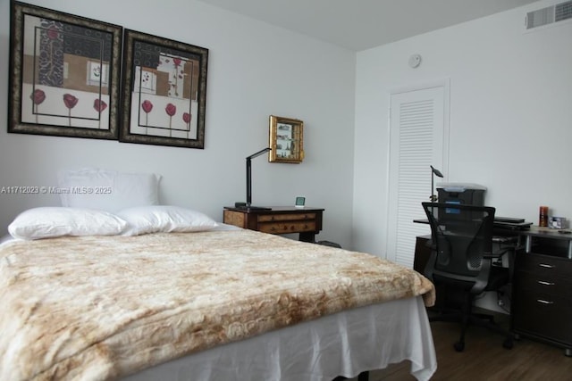 bedroom featuring visible vents and wood finished floors