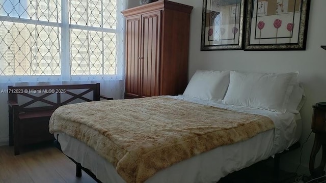 bedroom with light wood-style floors