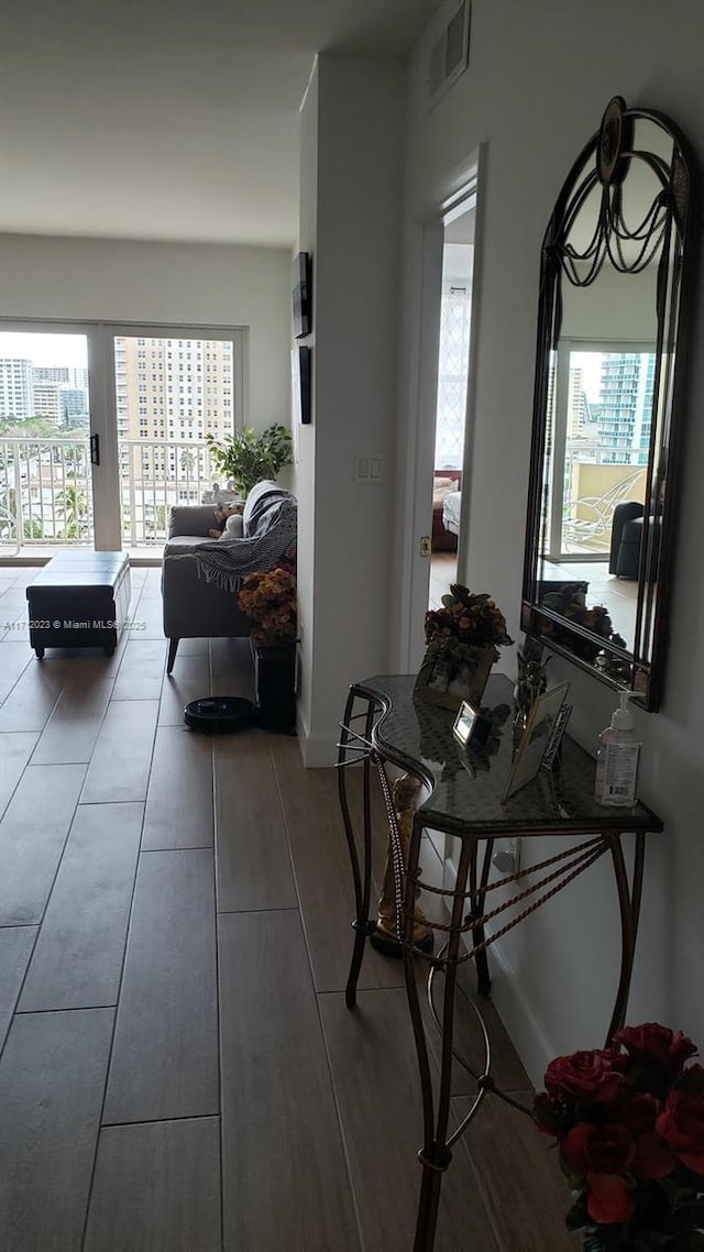 dining area featuring a city view, visible vents, and wood finished floors