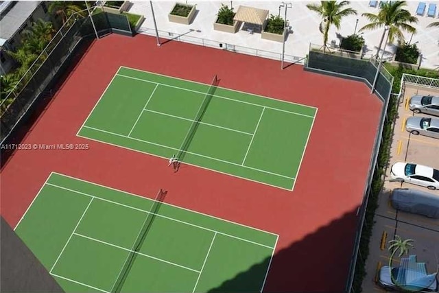 view of sport court featuring fence