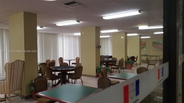 dining area featuring visible vents and a textured ceiling