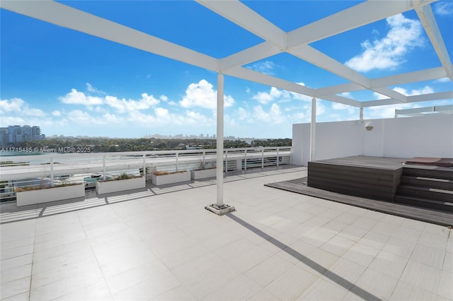 view of patio featuring a city view and a jacuzzi