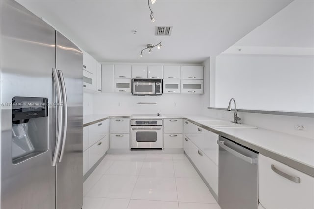 kitchen with white cabinets, stainless steel appliances, visible vents, and a sink