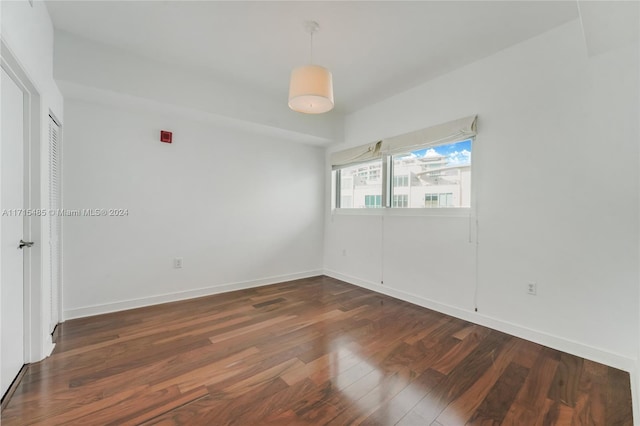 spare room with dark wood-type flooring