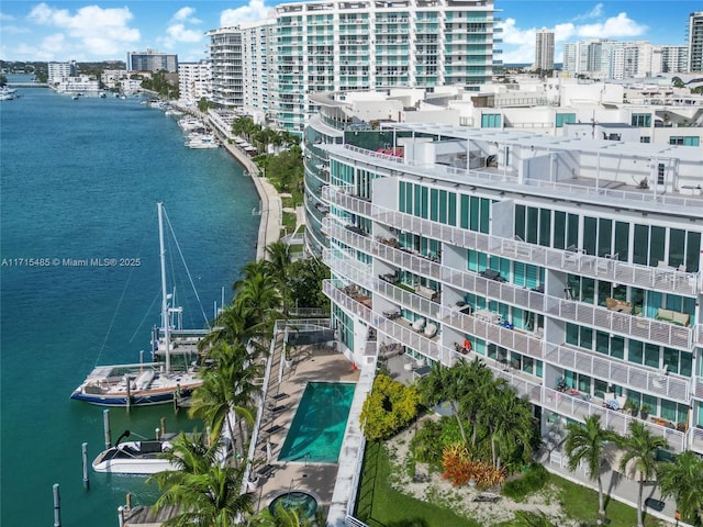 birds eye view of property featuring a city view and a water view