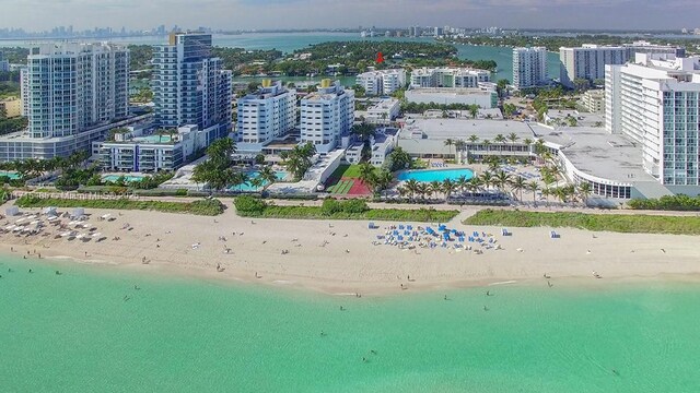birds eye view of property featuring a city view, a view of the beach, and a water view