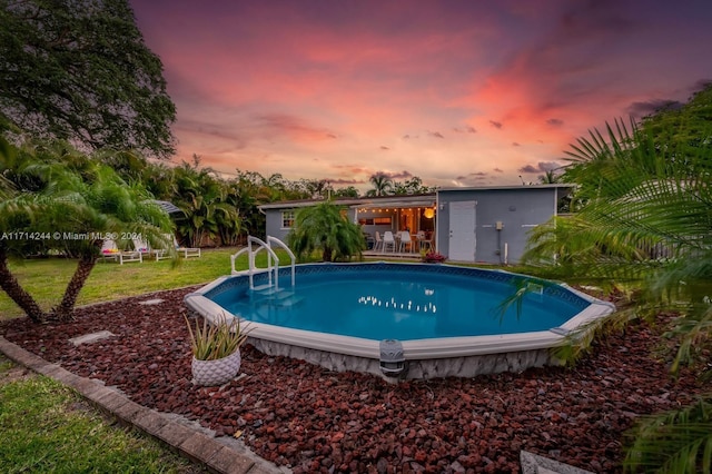 pool at dusk with a yard