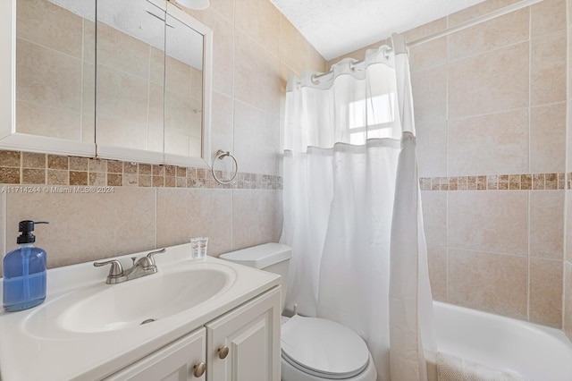 full bathroom with vanity, toilet, tile walls, and shower / tub combo with curtain