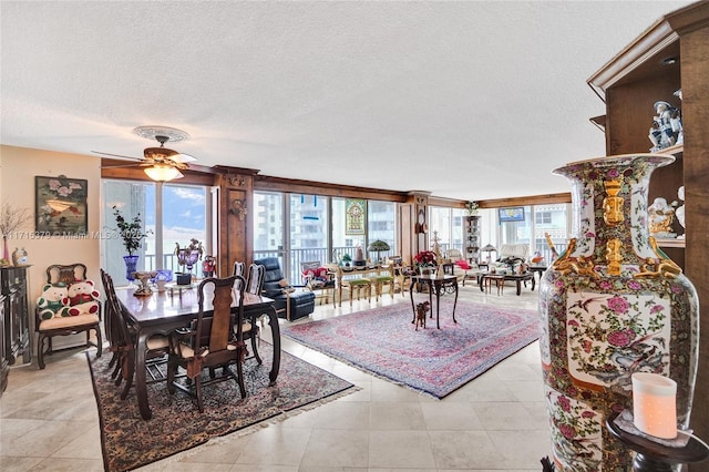 dining room featuring ceiling fan, light tile patterned flooring, and a textured ceiling