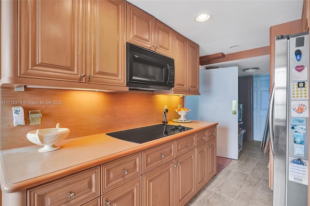 kitchen with light tile patterned flooring and black appliances