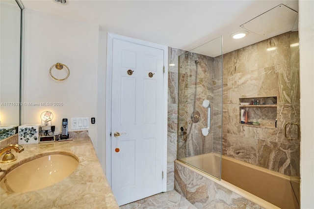 bathroom with vanity and tiled shower / bath