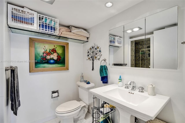 bathroom featuring toilet, an enclosed shower, and sink